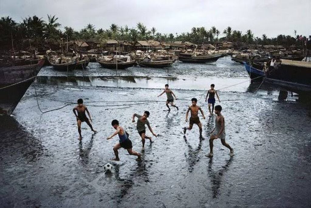 Boys Playing Soccer in the Rain