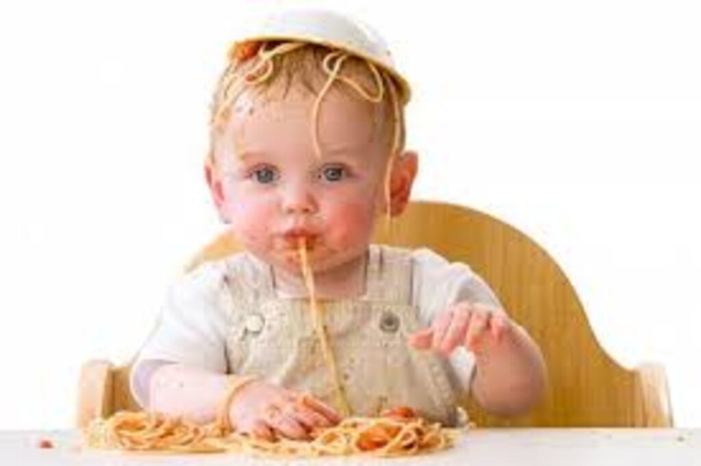 Toddler wearing an upturned bowl of spaghetti