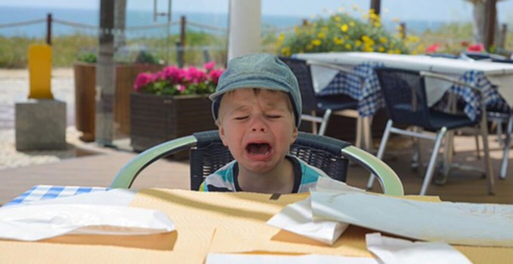 A child crying at an outdoor restaurant
