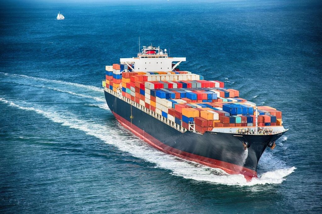 A shipping vessel at full speed on the sea.