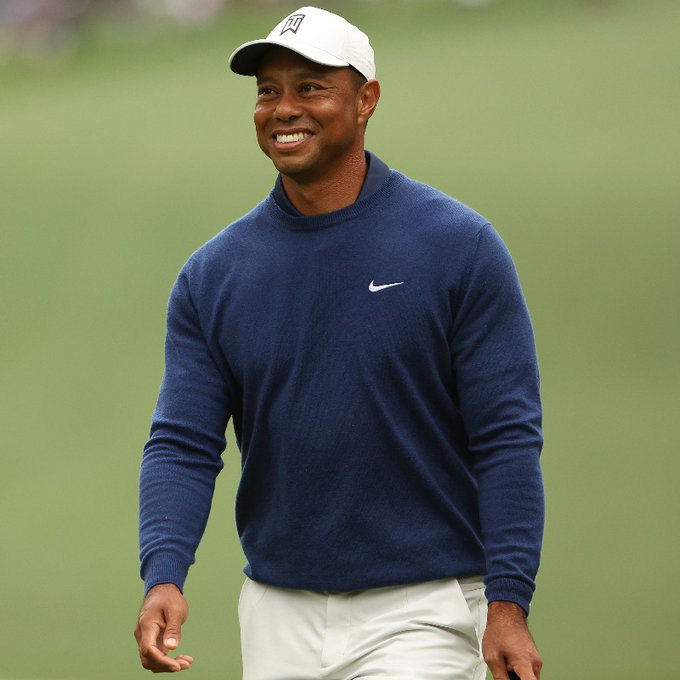 Woods smiling at fans during a tournament