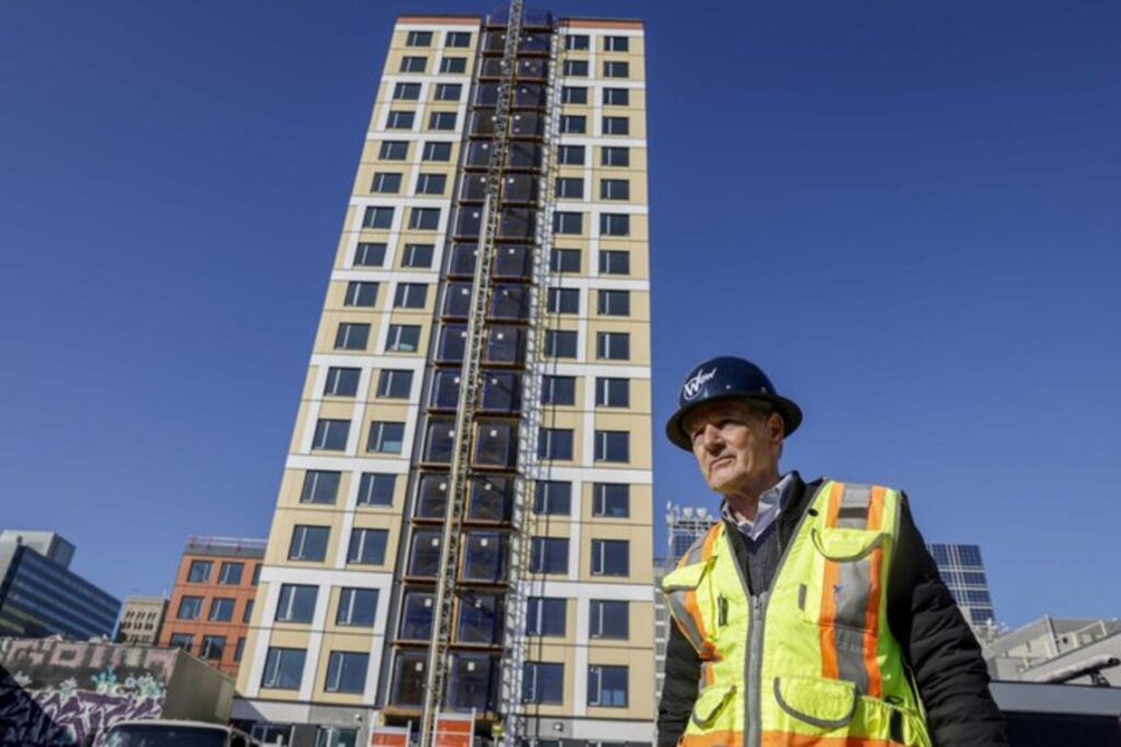 Estate developer in front of an 18-story residential building