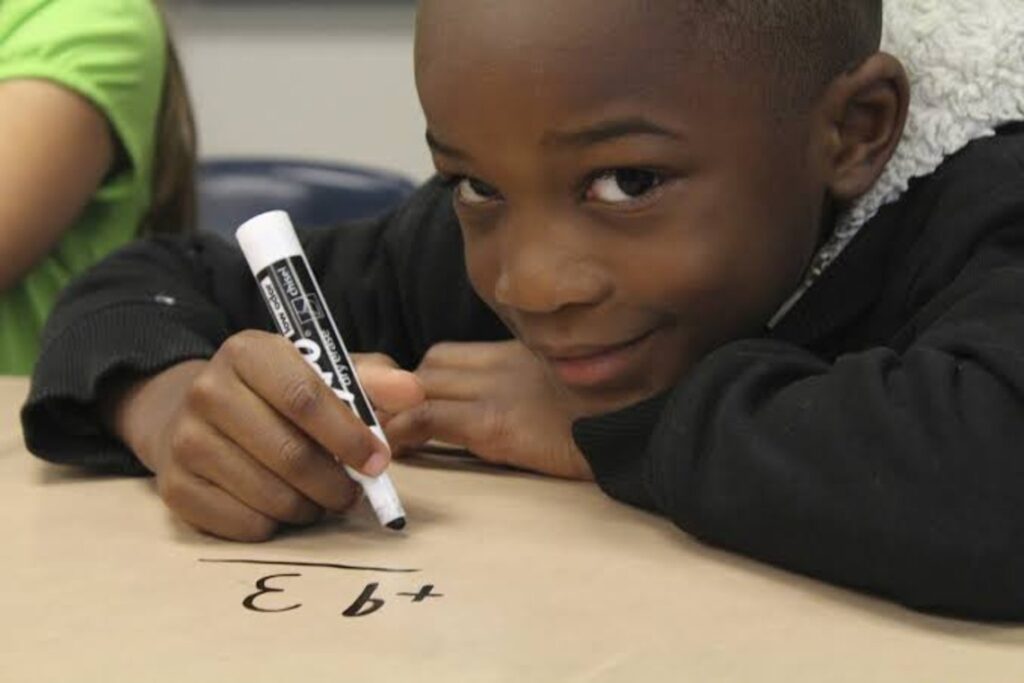 Boy looking up from a math problem