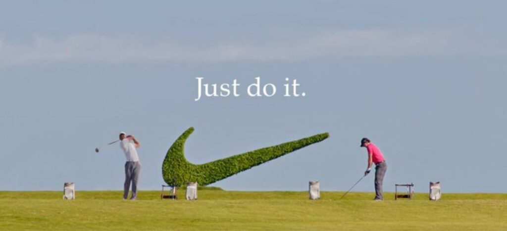 Golfers with a hedge of Nike logo in the background