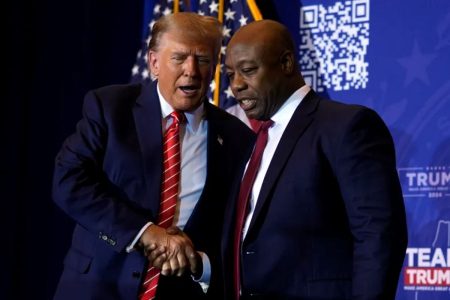 Senator Tim Scott and Former president Donald Trump shaking hands