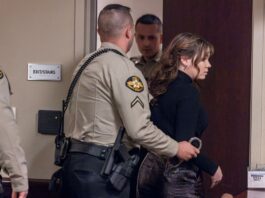 Photo of Hannah Guiterrez-Reed being handcuffed in court