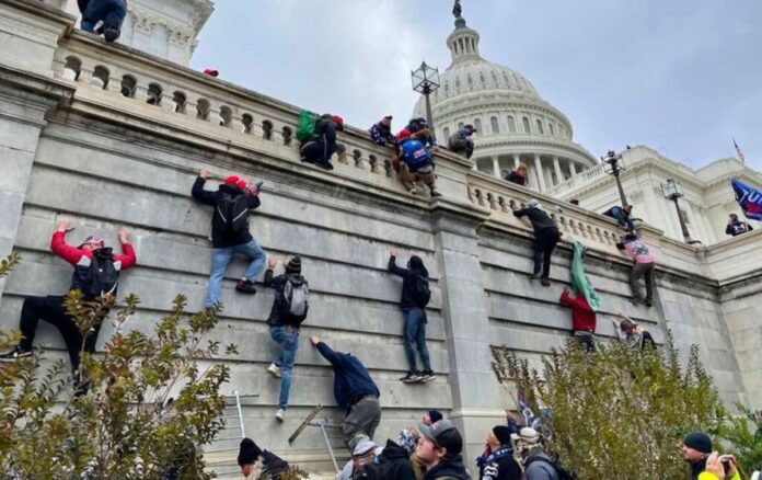 People Climbing the Fence During Capitol Riot