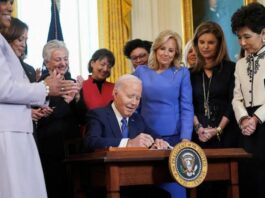 A picture of President Joe Biden signing the executive order