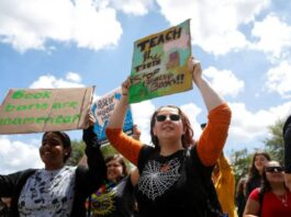 A picture of advocates protesting the classroom ban on gender identity discussions