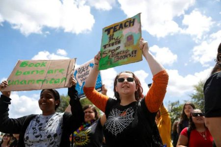 A picture of advocates protesting the classroom ban on gender identity discussions