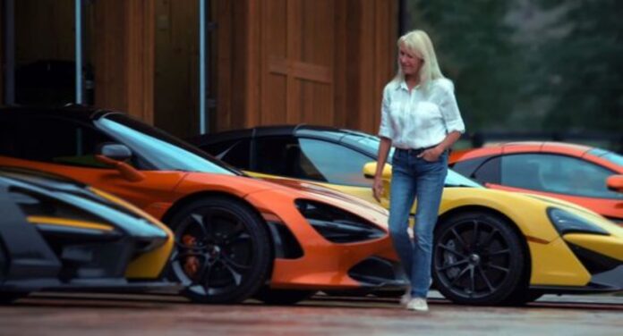 Kathy Cargill stands in the midst of her car collection