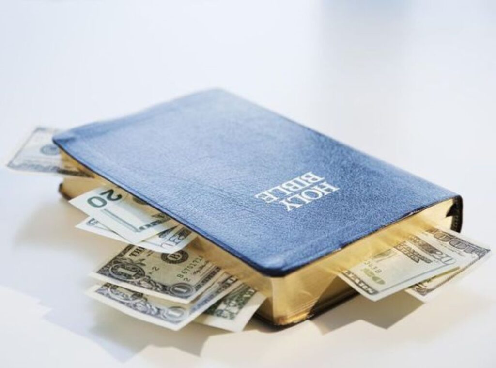 The Holy Bible With Dollar Bills