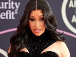 Cardi B posing for shots on a red carpet