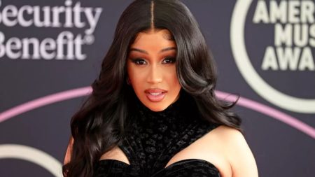 Cardi B posing for shots on a red carpet