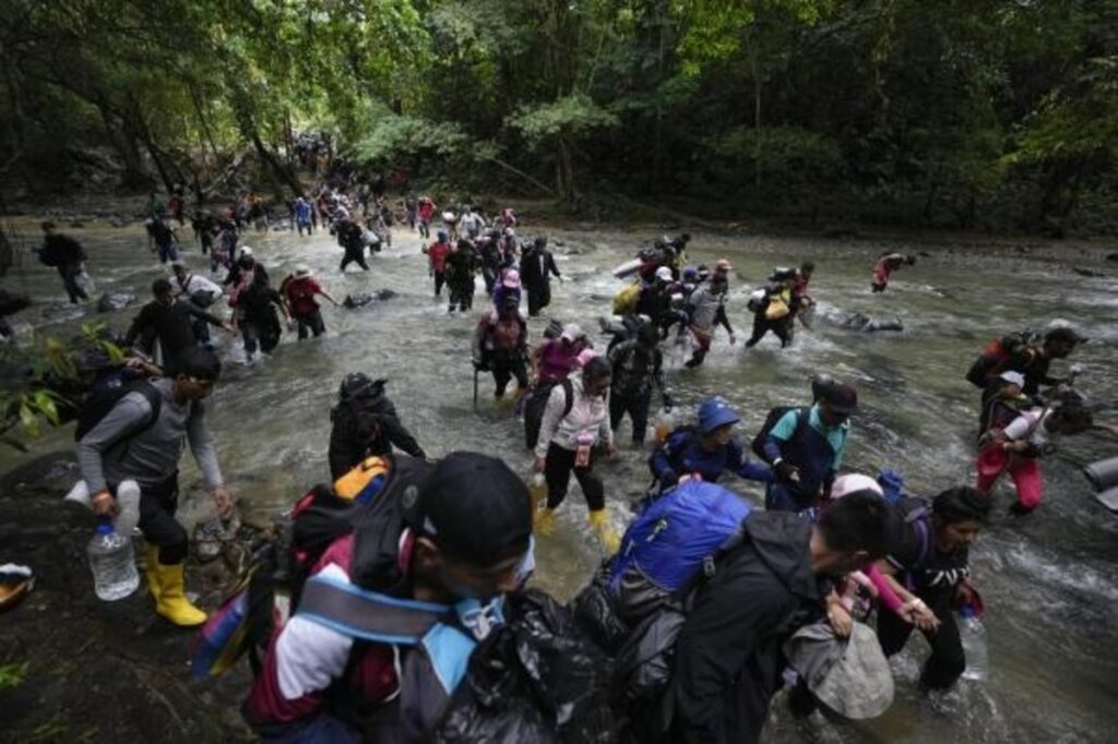 Migrants Crossing a River