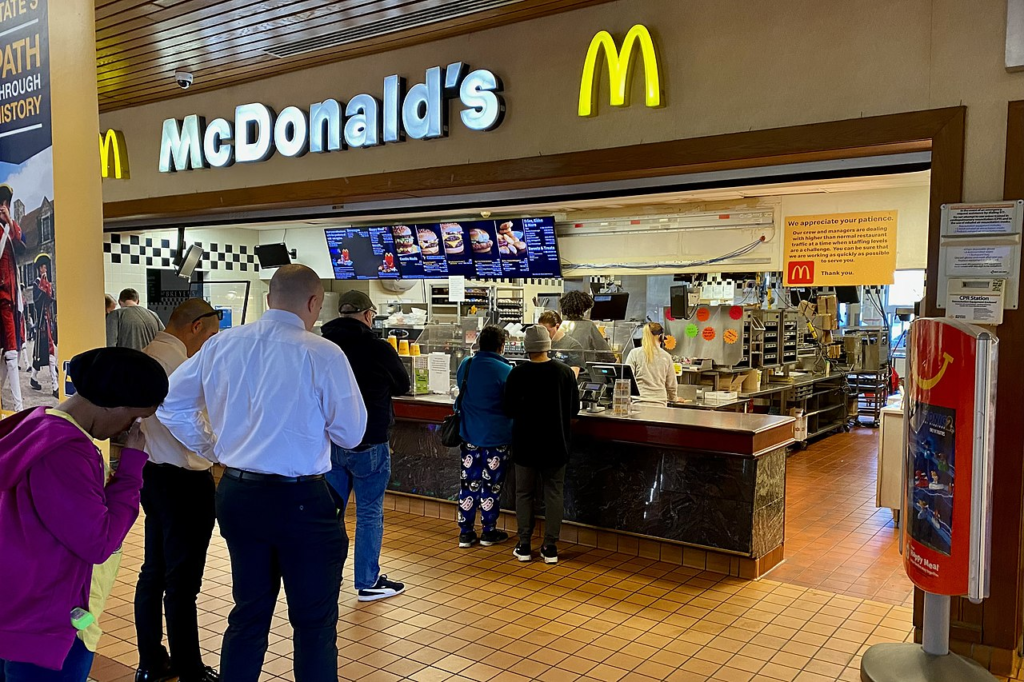 A long lone of customers waits for service at the McDonald's outlet