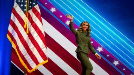 Lara Trump waving from atop a stage