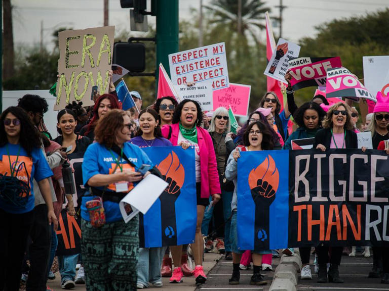 Demonstrators protest during a Women's March rally, Jan. 20, 2024, in Phoenix.