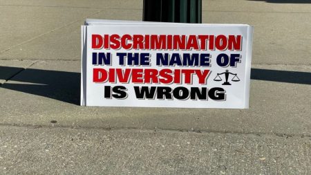 A Photo of a Placard that says "Discrimination in the name of Diversity is Wrong"