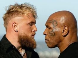 Photo of Jake Paul and Mike Tyson fiercely staring at each other