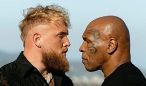 Photo of Jake Paul and Mike Tyson fiercely staring at each other