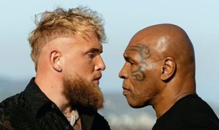 Photo of Jake Paul and Mike Tyson fiercely staring at each other