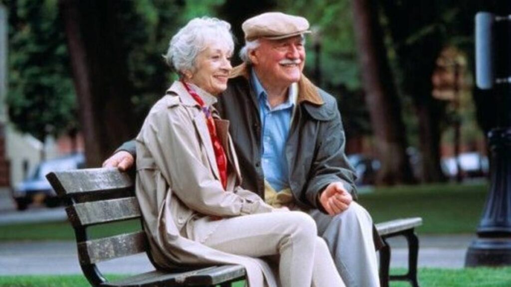 Old Couple Sitting on Park Bench Together