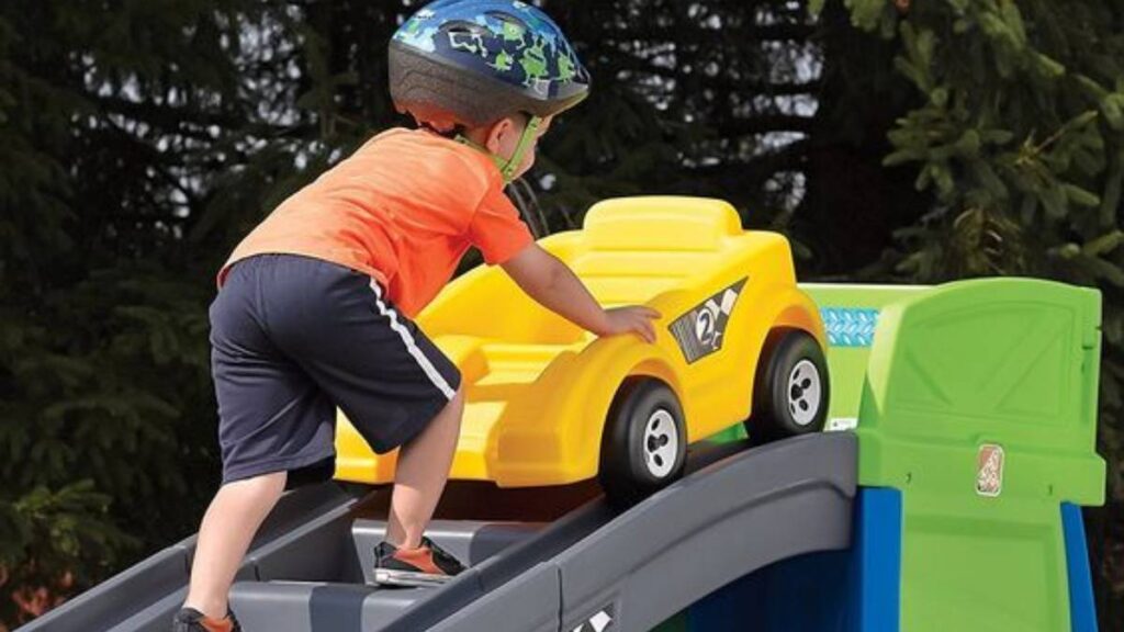 A boy playing with a toy car