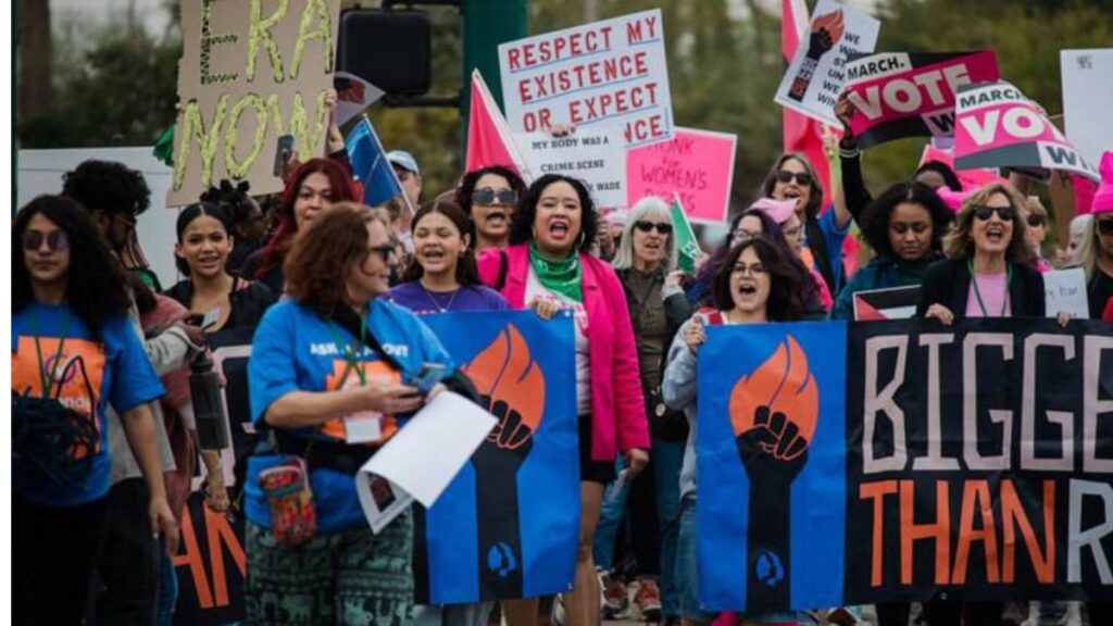 Demonstrators protest during a Women's March rally, Jan. 20, 2024, in Phoenix.