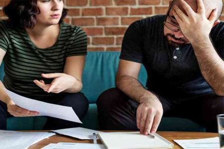 A picture of a couple arguing about money