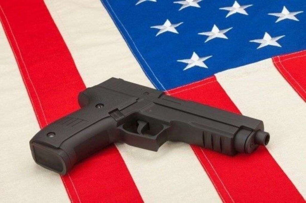 A handgun on top of a USA flag