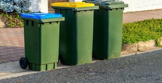 Garbage bins standing next to each other