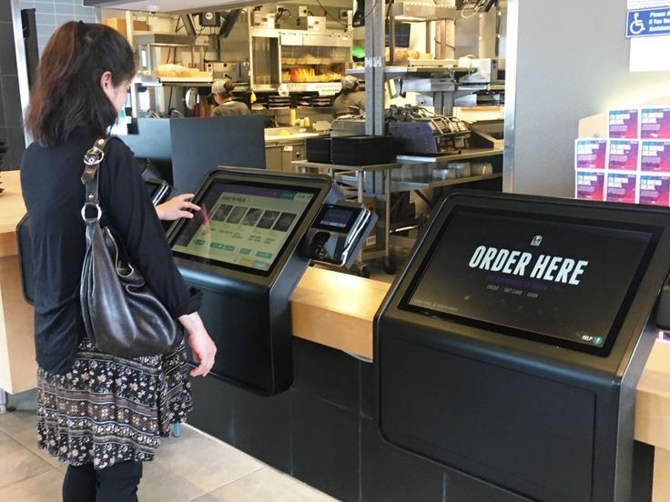 A customer interacting with a self-checkout machine