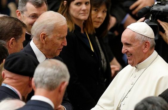 Pope Francis and Joe Biden exchanging pleasantries