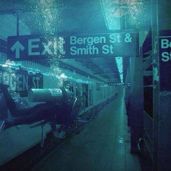 A diver exploring a submerged New York subway