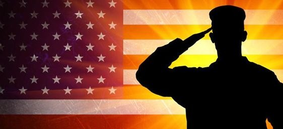 A silhouette of a saluting soldier against the backdrop of a US flag