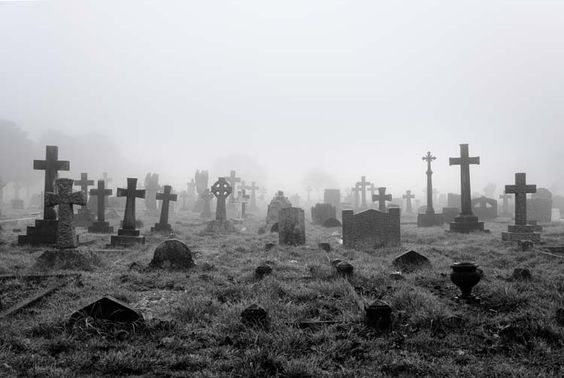 A black and white photo of a graveyard