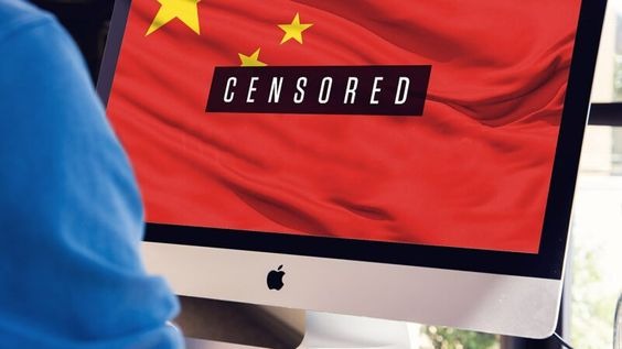An apple monitor showing the word censored against a backdrop of the Chinese flag