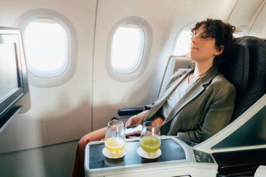 Lady sleeping after drinking on a plane.