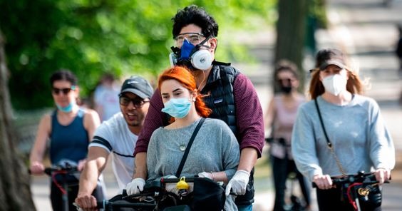 People on a street wearing protective masks