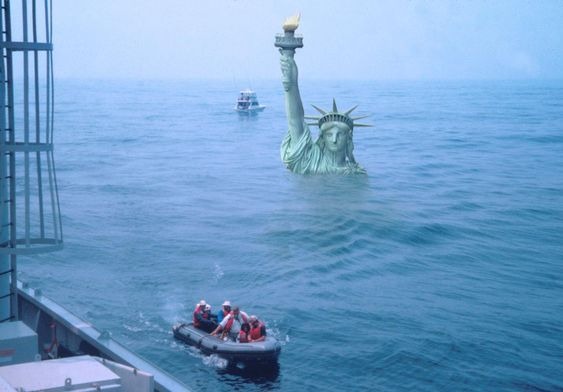 The statue of liberty almost completely submerged in a flooding