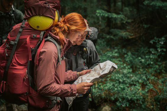Two hikers observing a map
