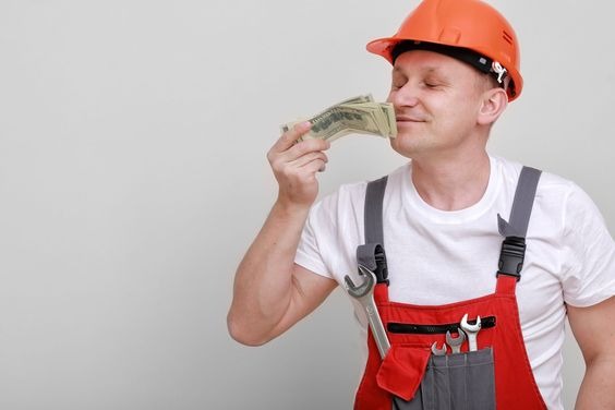 A worker smelling a wad of cash