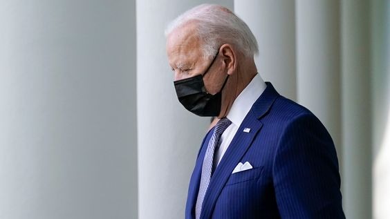 A side view of Biden with his mask on