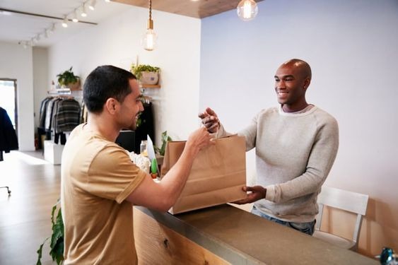 A man interacting with a staff at the counter