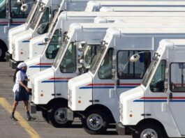 A picture of the U.S. postal service delivery trucks.