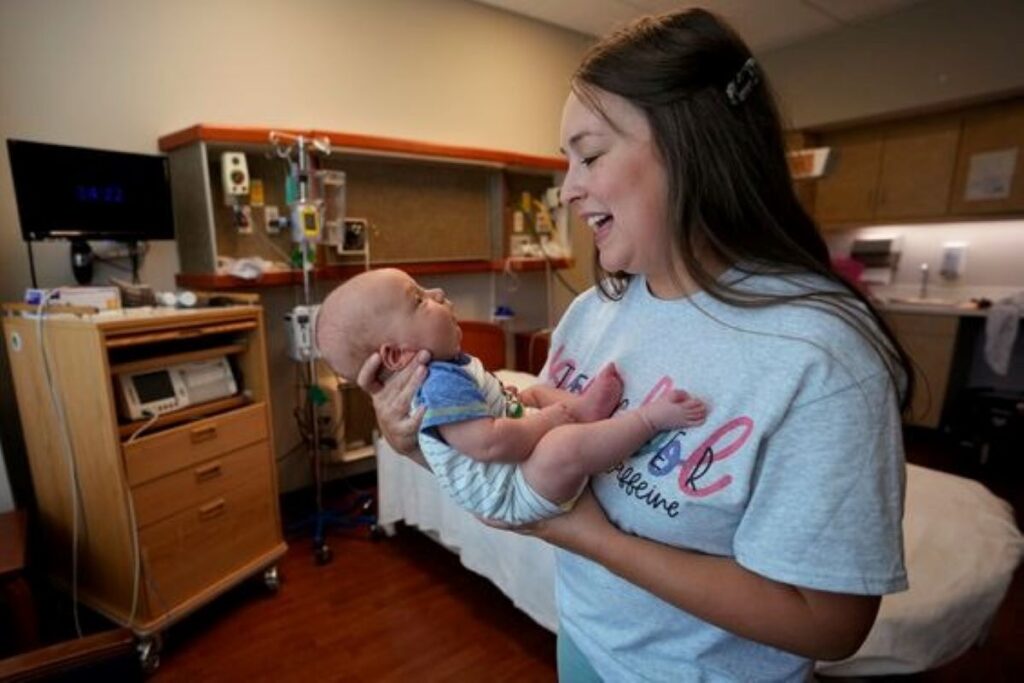 A smiling mother holding her baby