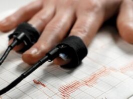 The hand of a person taking a polygraph test