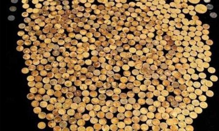 Coins from the Great Kentucky Hoard spread out against a dark background