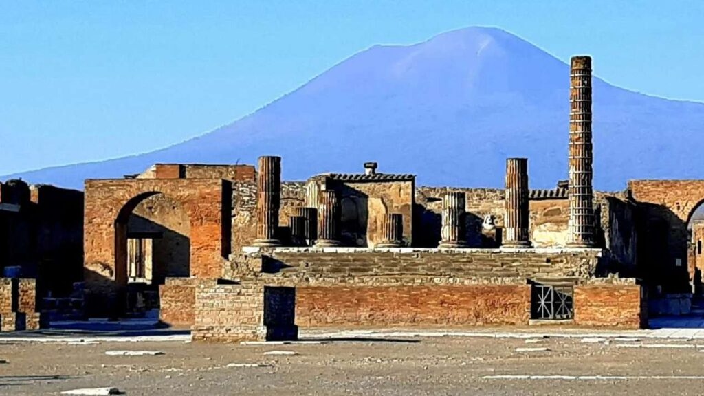 The lost city of Pompeii ruins seen with Mount Vesuvius behind it.